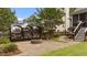 Backyard featuring a stone fire pit, a wood pile, green grass and nice landscaping at 1033 Mills St, Raleigh, NC 27608