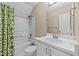 Bathroom with a shower-tub combo and a white vanity with sink and large mirror at 1033 Mills St, Raleigh, NC 27608
