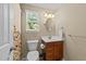 Clean bathroom with a wood vanity and neutral tones offering a functional and comfortable space at 1033 Mills St, Raleigh, NC 27608