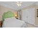 Inviting bedroom featuring a comfortable bed, overhead lighting, and a spacious closet at 1033 Mills St, Raleigh, NC 27608
