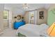 Cozy bedroom with blue dresser, ceiling fan, and natural light from the window at 1033 Mills St, Raleigh, NC 27608