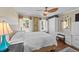 Bright bedroom features multiple windows, a ceiling fan, and ample storage space enhancing functionality and comfort at 1033 Mills St, Raleigh, NC 27608