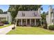 Charming home featuring a beautifully landscaped front yard, dormer windows and inviting porch with black shutters at 1033 Mills St, Raleigh, NC 27608