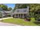 Lovely home with a manicured lawn, covered porch, dormer windows, and beautiful landscaping at 1033 Mills St, Raleigh, NC 27608
