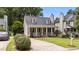 Quaint home with a driveway, lovely front yard, covered front porch and dormer windows at 1033 Mills St, Raleigh, NC 27608