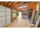 Spacious garage with storage shelves, workbench, and natural light from the windows at 1033 Mills St, Raleigh, NC 27608