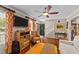 Cozy living room features a ceiling fan, hardwood floors, area rug and staircase at 1033 Mills St, Raleigh, NC 27608