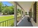 Inviting covered porch with black railings, decorative columns, and a pleasant view of the landscaped front yard at 1033 Mills St, Raleigh, NC 27608