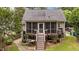 Charming screened porch with stairs leading to the landscaped backyard, perfect for outdoor enjoyment at 1033 Mills St, Raleigh, NC 27608