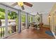 Relaxing screened porch with wicker furniture and ceiling fans, perfect for outdoor enjoyment at 1033 Mills St, Raleigh, NC 27608