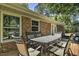 View of the back deck showcasing a metal outdoor table and chairs sitting outside the brick house at 104 S Tunstall St, Apex, NC 27502