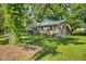 Exterior side view showing manicured lawn and landscaping of this charming home at 104 S Tunstall St, Apex, NC 27502