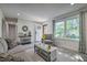 Bright living room with fresh decor, new flooring, and a large window for ample natural light at 104 S Tunstall St, Apex, NC 27502