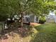 Fenced-in backyard with mature trees, grass, and a wooden deck at 10415 Neland, Raleigh, NC 27614