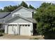 Charming two-story home with a two-car garage, light blue siding, and a well-maintained yard with mature trees at 10415 Neland, Raleigh, NC 27614