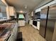 Functional kitchen featuring white cabinets, stainless steel appliances, tile floors and a window for natural light at 10415 Neland, Raleigh, NC 27614