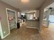Functional kitchen features white cabinets, updated appliances, tile floors and an adjacent open living space at 10415 Neland, Raleigh, NC 27614