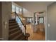 Open-concept living area with hardwood floors, a chandelier, and seamless flow to the staircase and other parts of the home at 10415 Neland, Raleigh, NC 27614