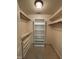 Bright walk-in closet with built in shelving and rod for hanging clothing at 10415 Neland, Raleigh, NC 27614