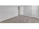 View of carpeted bedroom with a closet and connecting room with white walls at 106 Flue Ct, Oxford, NC 27565
