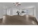 Open concept kitchen and living area featuring white cabinets, stainless steel appliances and wood-look floors at 106 Flue Ct, Oxford, NC 27565