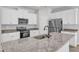 Modern kitchen featuring stainless steel appliances, granite countertops, white cabinets and a central island sink at 106 Flue Ct, Oxford, NC 27565