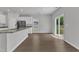 Bright eat-in kitchen with stainless steel appliances, white cabinets, and sliding glass doors to the backyard at 106 Flue Ct, Oxford, NC 27565