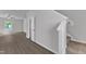Bright living room with sleek wood-look floors, a ceiling fan, and a staircase leading to the second floor at 106 Flue Ct, Oxford, NC 27565