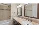 Bathroom with a double sink vanity, granite countertop, and tiled shower/tub combo at 11 Willow Bridge Dr, Durham, NC 27707