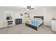 Bright bedroom featuring a ceiling fan and light-filled window with a chair and desk at 11 Willow Bridge Dr, Durham, NC 27707