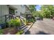 Townhome with a green exterior, steps, landscaping, and ample parking spaces at 11 Willow Bridge Dr, Durham, NC 27707