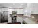 Bright kitchen features granite counters, stainless steel appliances and mosaic backsplash at 11 Willow Bridge Dr, Durham, NC 27707