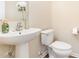 Bathroom featuring a pedestal sink, toilet, neutral paint, and modern fixtures at 1108 Forest Willow Ln, Morrisville, NC 27560