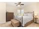 Cozy bedroom features a metal bed frame, dresser, and bench at the foot of the bed at 1108 Forest Willow Ln, Morrisville, NC 27560