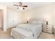 Bright bedroom featuring a large bed with upholstered headboard, and bench at the foot of the bed at 1108 Forest Willow Ln, Morrisville, NC 27560