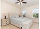 Spacious bedroom featuring a large bed with upholstered headboard, and bench at the foot of the bed at 1108 Forest Willow Ln, Morrisville, NC 27560