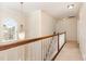 Bright upstairs hallway showcases a decorative chandelier and staircase access at 1108 Forest Willow Ln, Morrisville, NC 27560