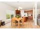 Open-concept kitchen and dining area features wood cabinets and light wood flooring at 1108 Forest Willow Ln, Morrisville, NC 27560