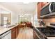 Open-concept kitchen features stainless appliances and an adjacent dining area and living room at 1108 Forest Willow Ln, Morrisville, NC 27560