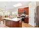 Well-lit kitchen showcases stainless steel appliances, wood cabinets, and center island with sink at 1108 Forest Willow Ln, Morrisville, NC 27560