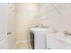 Well-lit laundry room features a utility sink, washer, dryer and built-in shelving for storage at 1108 Forest Willow Ln, Morrisville, NC 27560