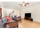 Bright living room with hardwood floors, a ceiling fan, and comfortable seating arrangement at 1108 Forest Willow Ln, Morrisville, NC 27560