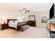 Spacious main bedroom featuring neutral carpet, a ceiling fan, and natural light from the windows at 1108 Forest Willow Ln, Morrisville, NC 27560