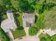 Aerial view of a home with a spacious backyard and patio area, nestled among mature trees providing shade and seclusion at 113 Chestone Ct, Cary, NC 27513