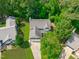 Aerial view of a home with a well-manicured lawn surrounded by lush, mature trees creating a private and peaceful setting at 113 Chestone Ct, Cary, NC 27513