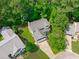 Aerial view of a home with a well-manicured lawn surrounded by lush, mature trees creating a private and peaceful setting at 113 Chestone Ct, Cary, NC 27513