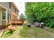 Backyard has a swing, large back deck, mature trees, and outdoor seating at 113 Chestone Ct, Cary, NC 27513