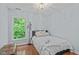 Cozy bedroom with hardwood floors, natural light, and modern light fixture at 113 Chestone Ct, Cary, NC 27513