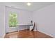 Bright bedroom features hardwood floors, a large window, and neutral colored walls at 113 Chestone Ct, Cary, NC 27513