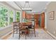 Bright dining area featuring hardwood floors, stylish chandelier, and an open view of the kitchen at 113 Chestone Ct, Cary, NC 27513
